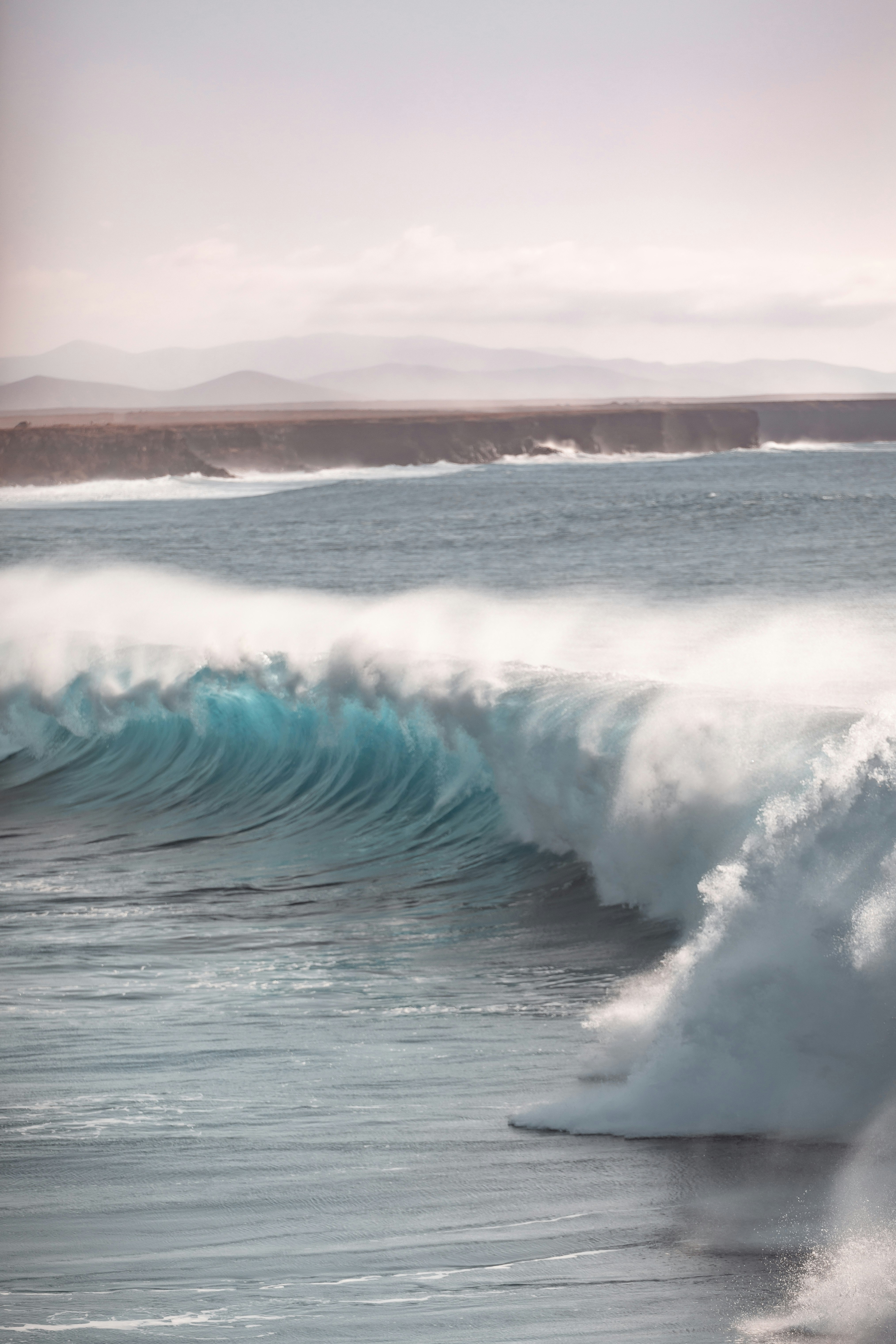 sea waves crashing on shore during daytime